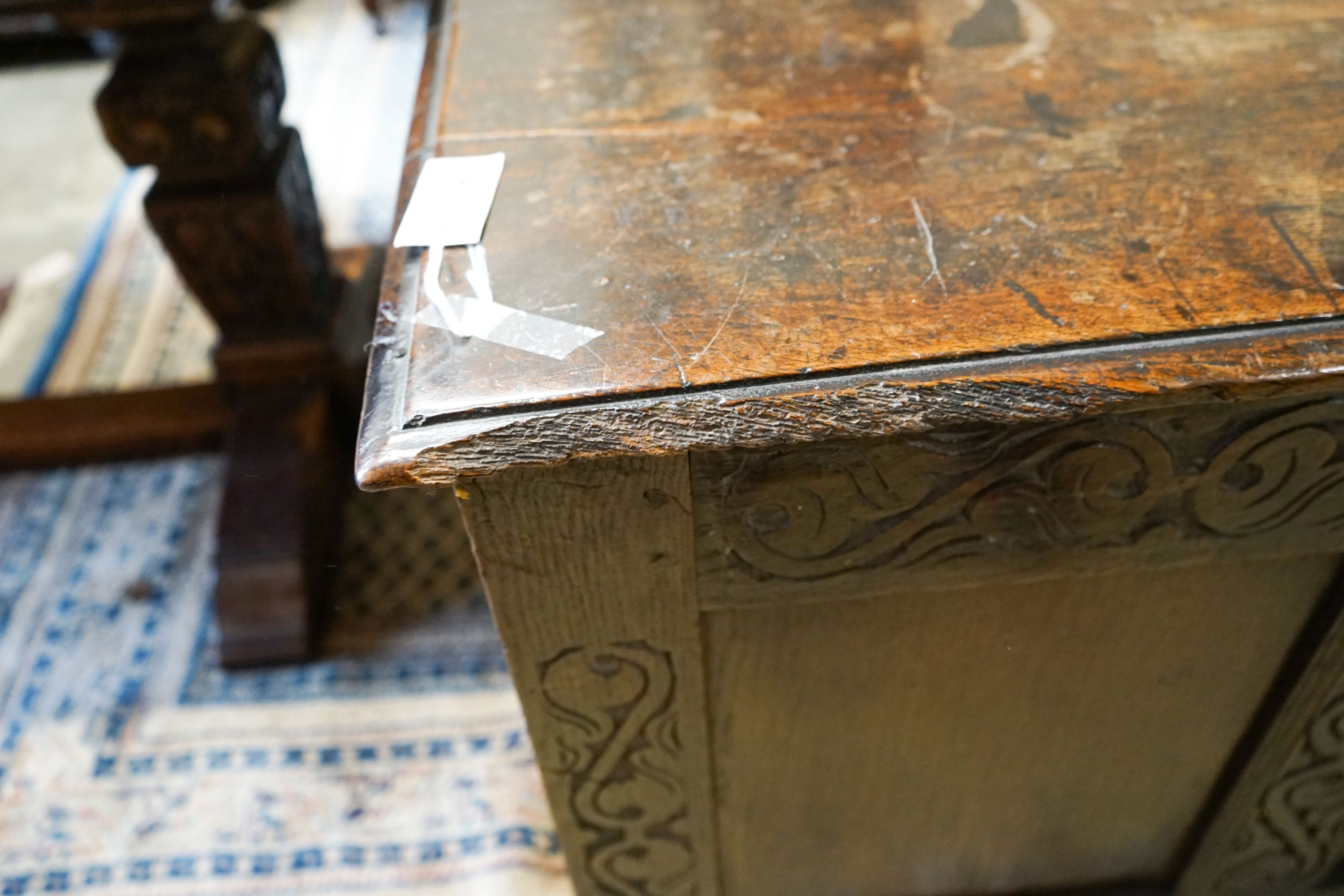 A late 17th / early 18th century carved and panelled oak coffer, length 136cm, depth 58cm, height 66cm